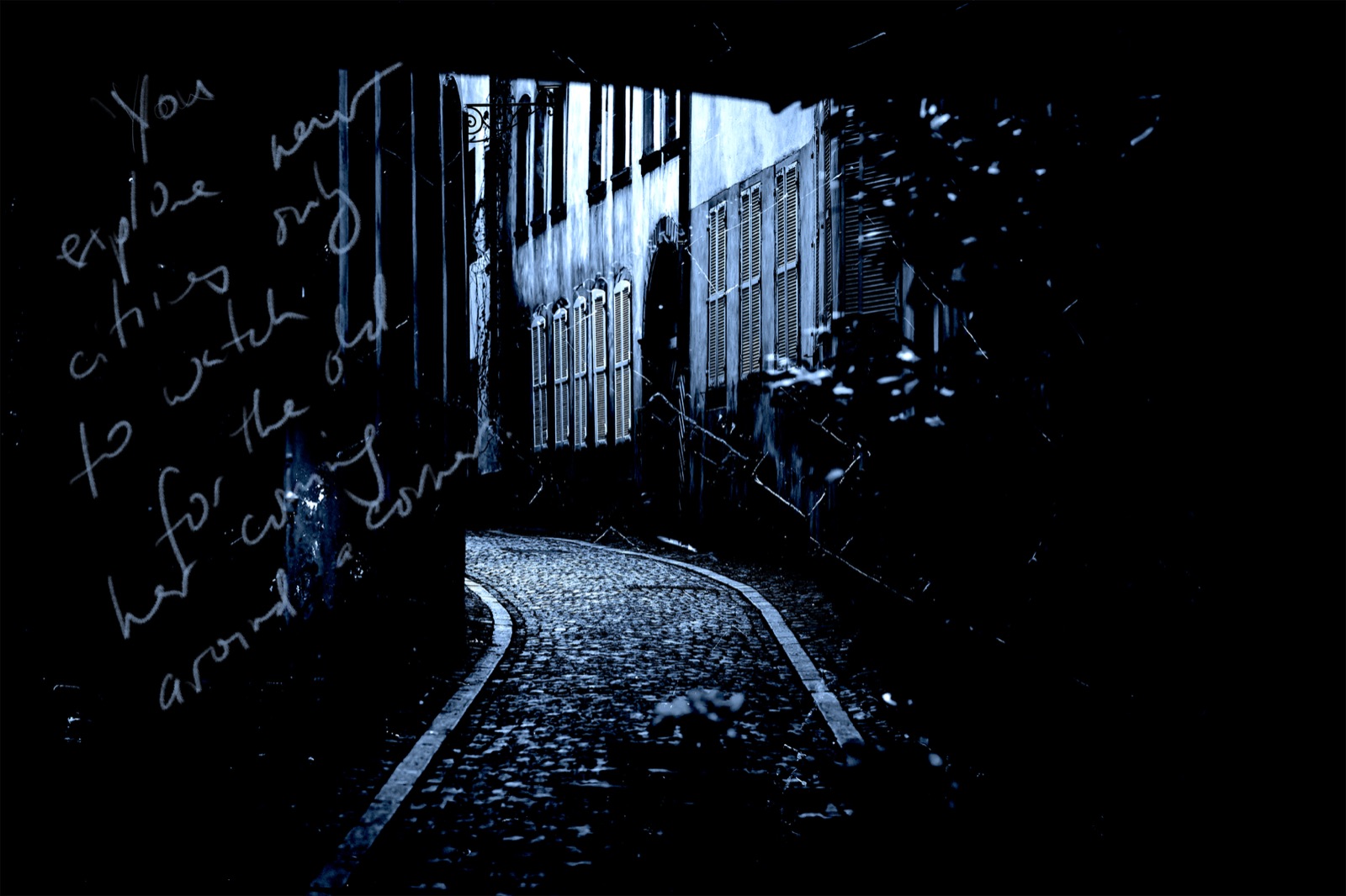 A dark cobbled lane with half-timbered houses, handwriting across the image