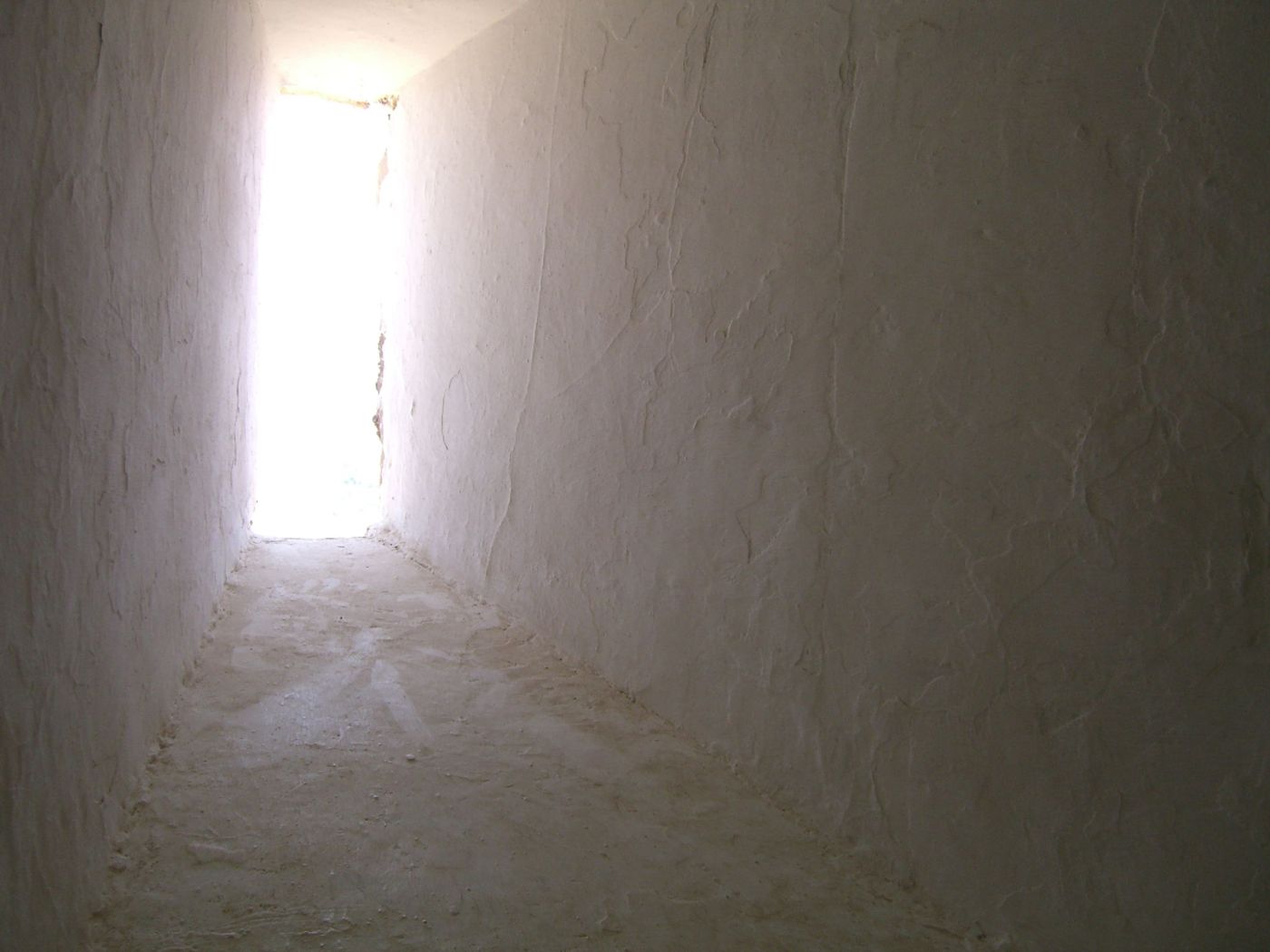 Light at the end of a narrow whitewashed passage