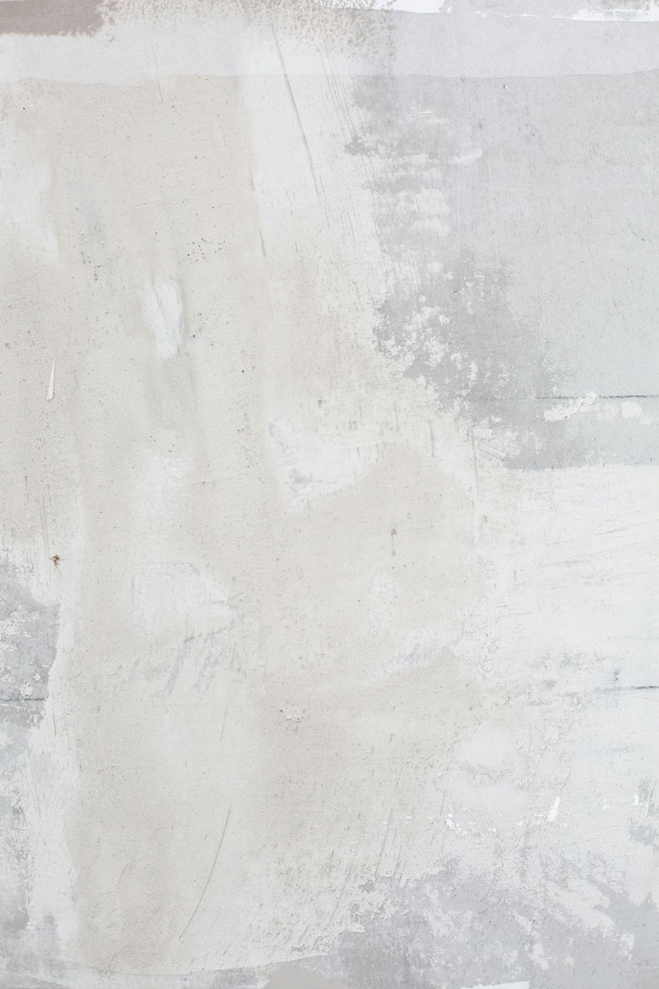 A pale, worn plaster wall