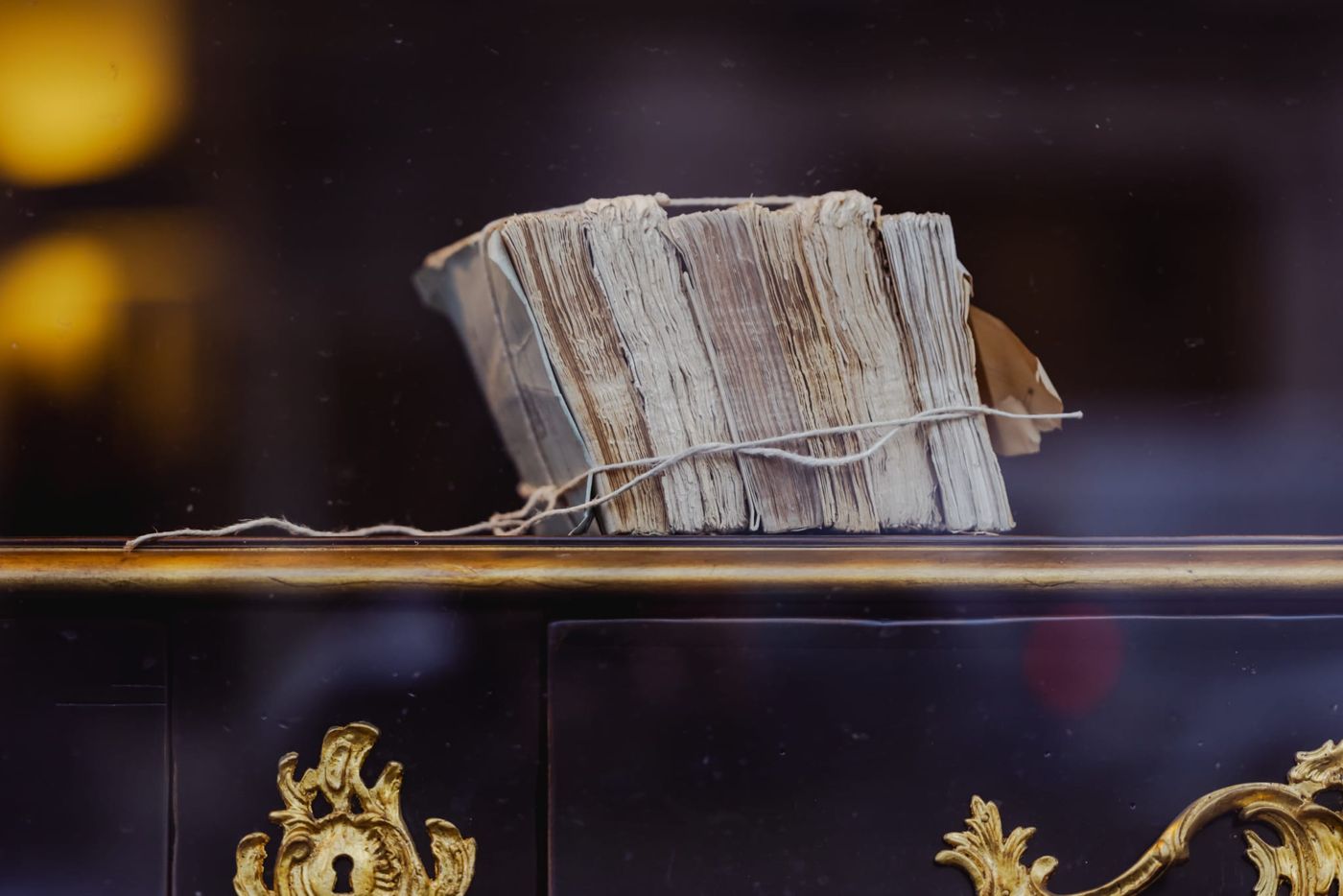 Old books tied with string in a Paris shop window